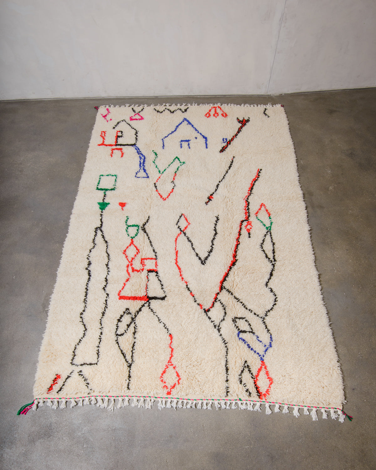 Decorative rug with colourful geometric patterns on a plain background